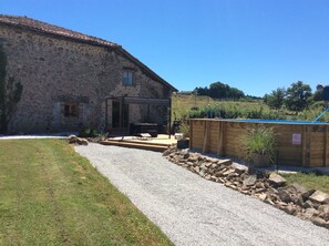 A stone building with a patio area, a pool, and a gravel path. - Beautifully converted barn ideal for 2/6 people couples or families,golf,cycling (Chassenon)