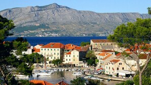 Explore the historic waterfront area with its charming marina, traditional buildings, and breathtaking mountain views.
