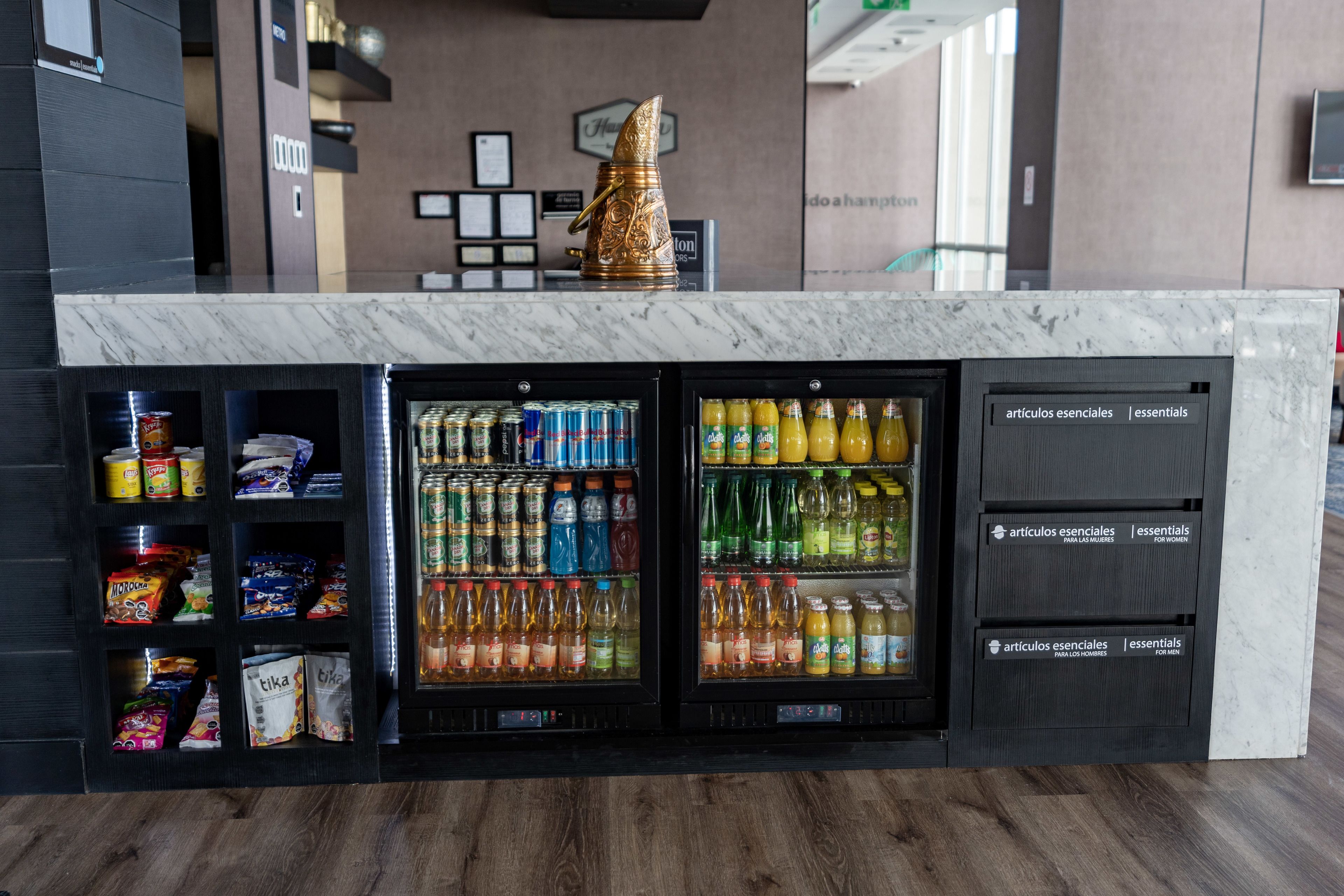 A self-service beverage station with a variety of drinks and snacks.