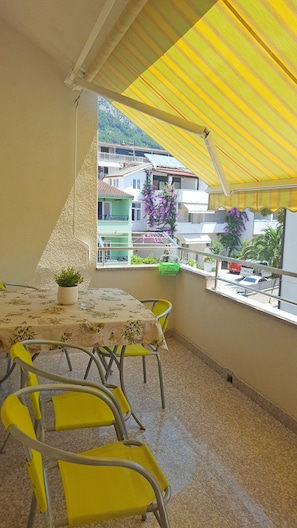 Enjoy a romantic meal for two on this balcony with a table set amidst lush views.