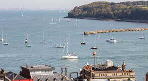 A harbor with multiple sailboats and yachts, a breakwater, and buildings in the foreground. - Cliffhanger, Cowes.  Stunning period property with fabulous sea views, sleeps 10 (Cowes)
