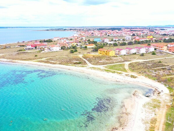 Experience the charm of a vibrant coastal town with its picturesque beach and inviting waters.