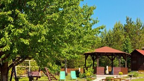 A rustic outdoor area with a wooden gazebo, a small bridge, and a picnic table. - Rooms Zdravko, (15054), Rudanovac (Korenica), hr (Rudanovac (Korenica))