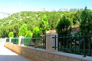 Surrounded by lush gardens and majestic mountains, this serene outdoor space offers a peaceful retreat.