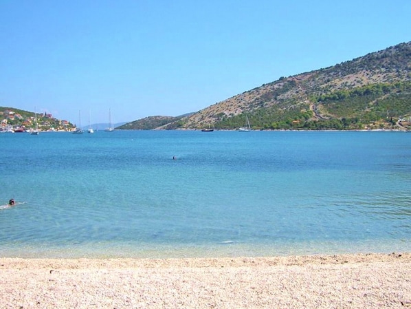 Enjoy a serene coastal escape with breathtaking views of the ocean and surrounding hills.