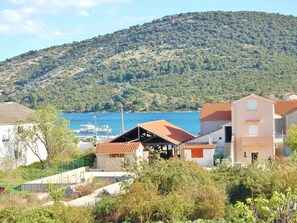 Stunning coastal homes nestled among lush greenery with breathtaking sea views.