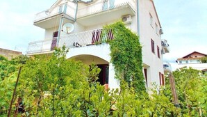 A two-story building with a balcony, surrounded by greenery. - Apartments Ivana, (10900), Vodice, hr (Vodice)