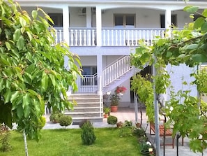 Stunning two-story building with a central staircase and beautifully maintained grounds.