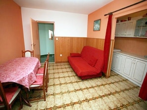 Cozy retreat with a single bed, compact dining area, and ample storage.