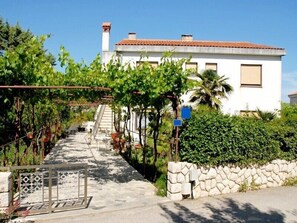Stunning Mediterranean-style residence surrounded by lush greenery and a beautifully maintained garden.