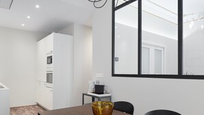 A modern kitchen with white cabinets and a built-in oven. - Always Easy I Catedral (San Sebastián/Donostia)