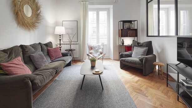 A modern living room with a sofa, armchair, coffee table, and a bookshelf. - Always Easy I Catedral (San Sebastián/Donostia)