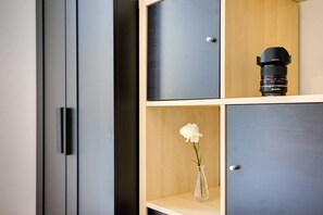 A modern cabinet with a camera lens and a white flower. - San Lorenzo Home - central location (Roma)