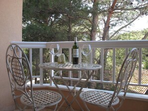 Enjoy a quiet drink on the balcony with a view of the surrounding trees.
