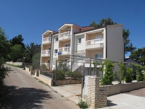 Stunning multi-story building with balconies and a gated entrance.