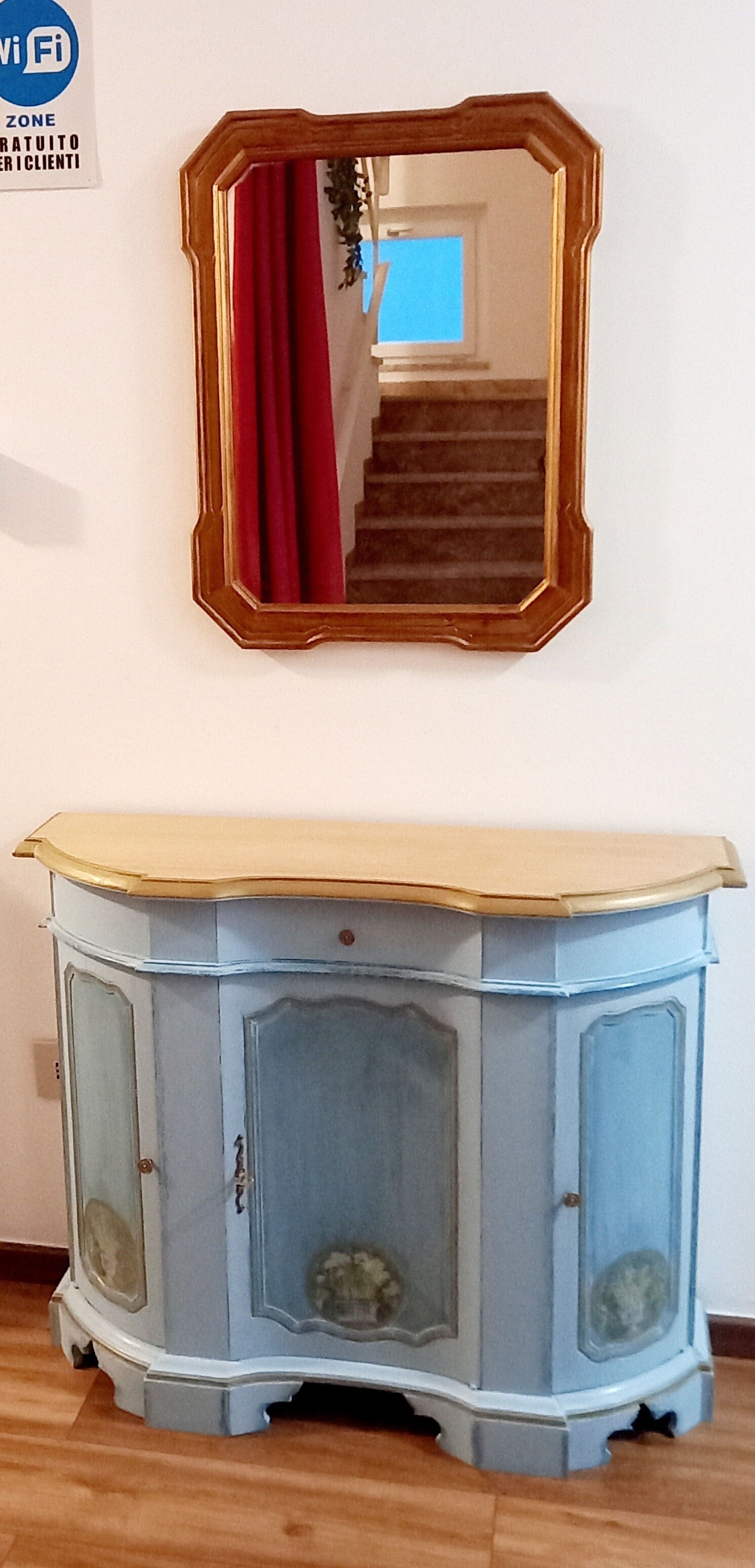 A blue cabinet with a light-colored top against a white wall.