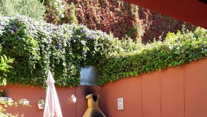 An outdoor patio with a pizza oven, seating area, and potted plants. - Casas Rurales Los Arrayanes for 4 people (Ronda)