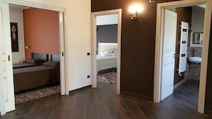 A hallway leading to a bedroom with a bed, a bathroom with a sink, and a shower. - Apartment in villa with use Pool. Terrace, Parking (Agrigento)