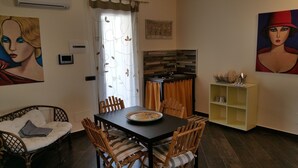 A dining area with a table, chairs, and a buffet cabinet. - Apartment in villa with use Pool. Terrace, Parking (Agrigento)