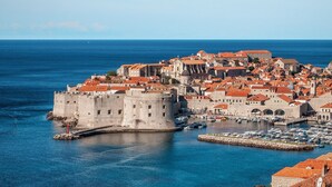 A coastal city with historic architecture, a prominent fortress, and a marina with boats. - Private oasis for up to 6 adults with swimming pool, sea view & 2 beaches nearby (Marušići)