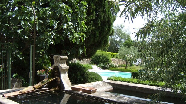 A stone fountain with a water feature in a garden setting. - Provence-Charming house with garden and swimming pool, up to 10 people (Sainte-Cécile-les-Vignes)