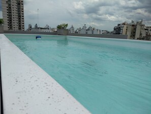 A rooftop pool with a view of a cityscape. - Independencia 1302 9C by HB (Buenos Aires)