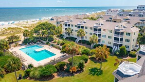 A resort with a swimming pool, beach access, and multiple-story buildings. - Direct Oceanfront w/ Views! Pool Access, screened porch - 202B Port O Call (Isle of Palms)