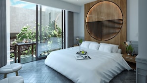 A modern bedroom with a large bed, a wooden accent wall, a dining area with a table and chairs, and a view of greenery outside. - Singular Joy Downtown Residences (Playa del Carmen)