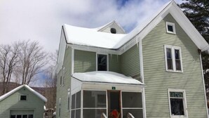 A two-story house with a covered porch and a garage.