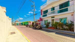 A street view of a hotel with a sign reading "Villa Elena." - 1BR with balcony (Isla Mujeres)