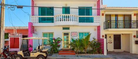 A two-story building with a sign reading "Villa Elena."