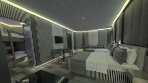 A modern hotel room with a bunk bed, a flat-screen TV, a sofa, a coffee table, and a bedside table. - Tryp By Wyndham Istanbul Sancaktepe (Istanbul)
