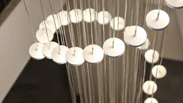 A modern chandelier with multiple circular light fixtures suspended from a central point.