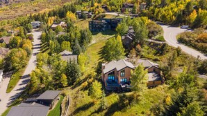 A residential area with houses surrounded by trees and a winding road. - Spectacular Home with Lovely Views & Hot Tub, Minutes from Beaver Creek and Vail (Eagle Vail)