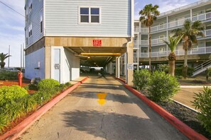 A building with an 'EXIT ONLY' sign above a covered walkway.