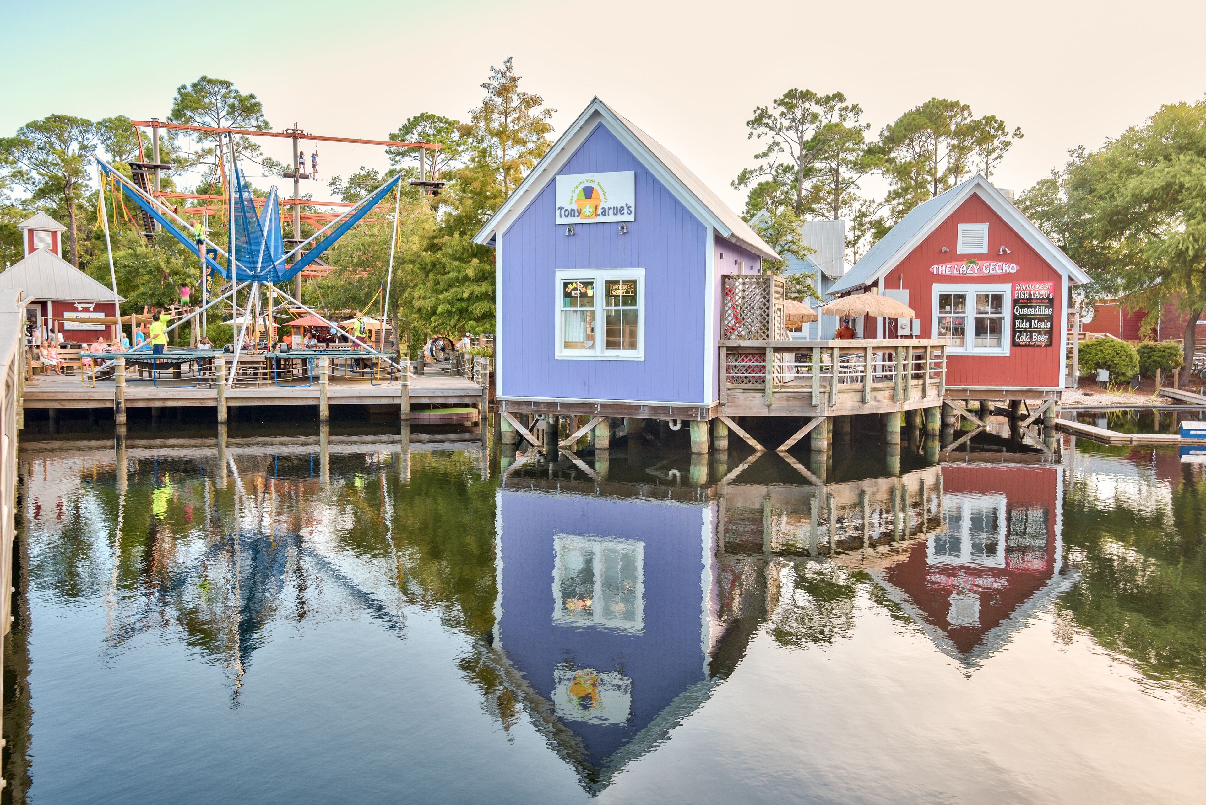 A water-themed attraction with two buildings, one blue and one red, featuring a sign for 'Tony Larve's' and 'The Lazy Gecko'.