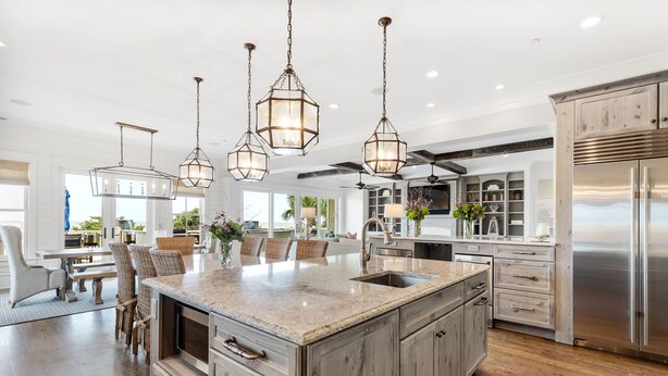A spacious kitchen with a large island, stainless steel appliances, and pendant lighting. - Stay @ Sea Star on Isle of Palms (Isle of Palms)