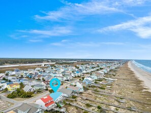 An aerial view of a coastal residential area with houses, a beach, and a clear sky. - "Holden You" - Oceanfront Home w/ Pool, 5 Bedrooms / 3 Bathrooms (Holden Beach)