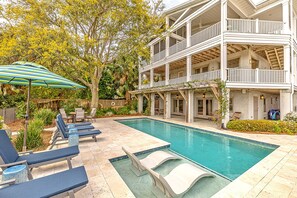 A pool area with lounge chairs and a covered patio. - Immaculate Private Ocean Front Escape | Easy Walk To Beach | Private Pool (St. Simons Island)