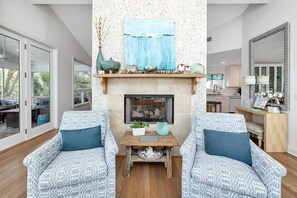 Flat-screen TV, fireplace, books