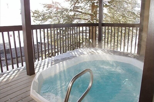 Building hot tub on first floor with a slope view