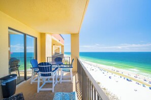 A balcony with a view of a beach and ocean. - PREMIUM One Bedroom at Phoenix V! (Orange Beach)