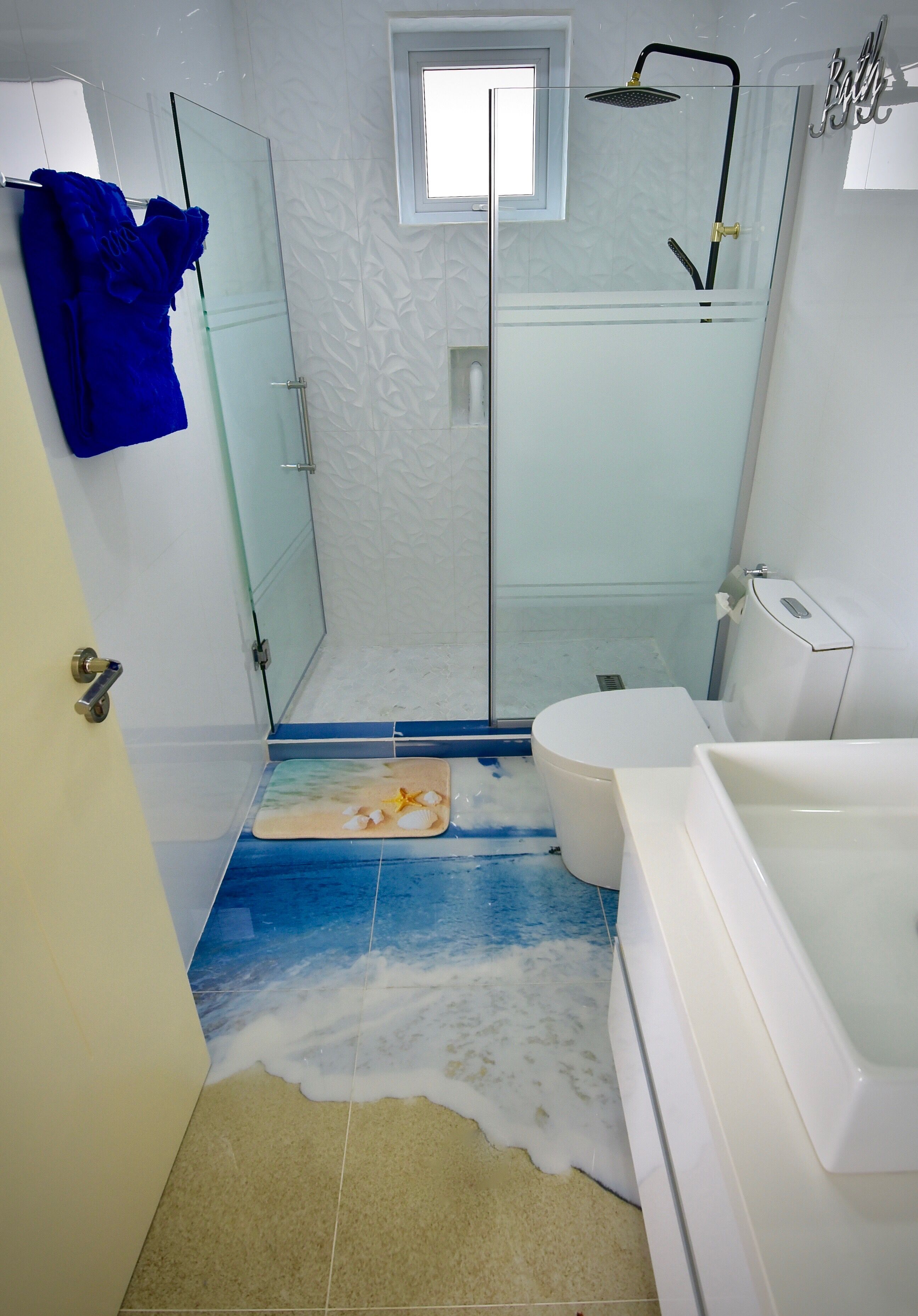 A bathroom with a glass-enclosed shower, a white toilet, and a bathtub.