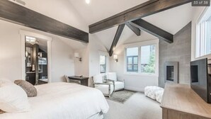 A bedroom with a large bed, a desk, a chair, a fireplace, and a window. - 3 min walk to Ski/bike main PCMR lift or Main Street!August and September deals! (Park City)