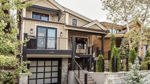 A multi-story house with a garage, a staircase, and a stone wall. - 3 min walk to Ski/bike main PCMR lift or Main Street!August and September deals! (Park City)
