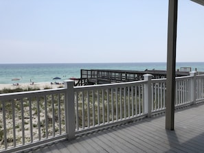 Enjoy breathtaking ocean views from this elevated deck overlooking the sandy shore.