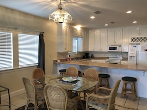 Enjoy cooking in this well-equipped kitchen with a central island, microwave, and stainless steel refrigerator.