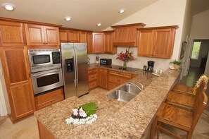 Enjoy cooking in this fully equipped kitchen with a sink, refrigerator, oven, and microwave.