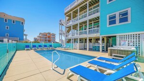 A pool area with blue lounge chairs and a hot tub. - Premier Oceanfront Dog Friendly w/ Pool, Hot Tub, Elevator, Theater and Game Rms (Rodanthe)
