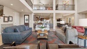 A spacious living area with a high ceiling, a dining area, and a kitchen. - Paintbrush Retreat: Private Pool and Hot Tub, Movie Theater + Paradise Village W (Santa Clara)
